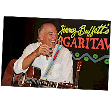 Photo of Jimmy Buffett with a guitar